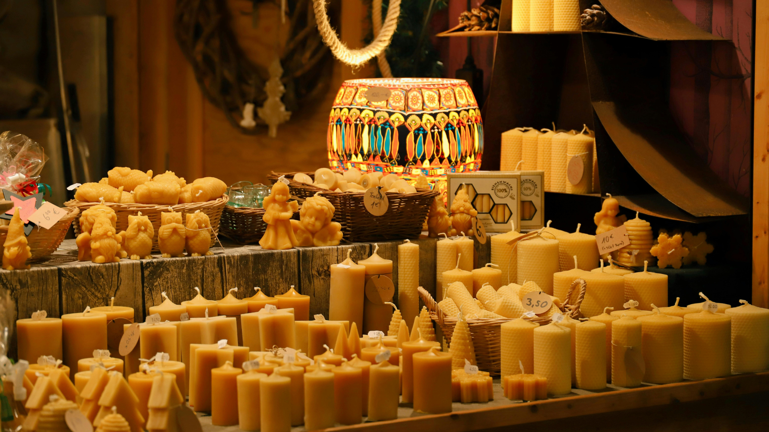 Display of various candles including beeswax and scented candles at a market. Luxzerna Philippines